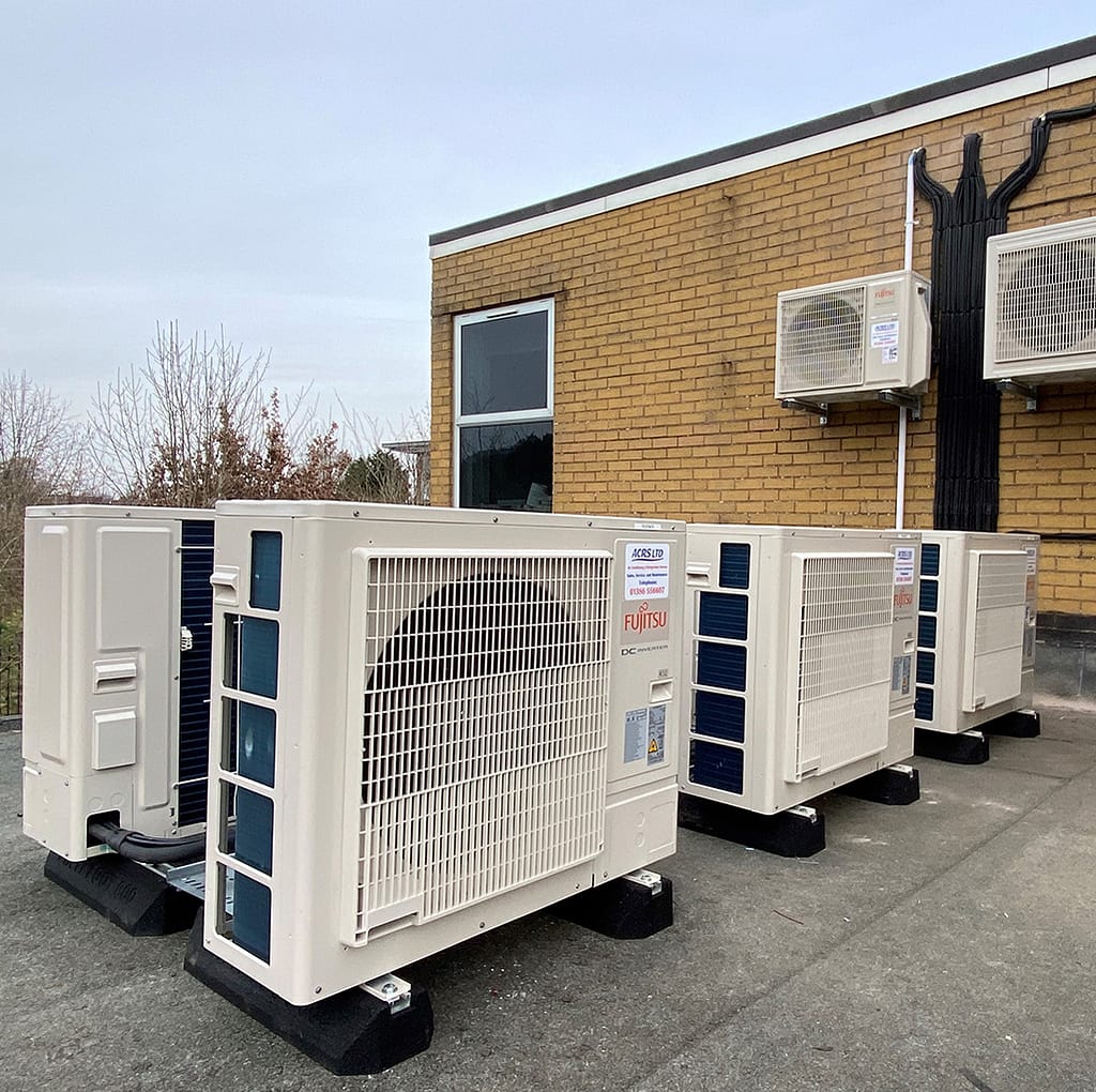 A group of air conditioning condensers located on a flat roof at Chase School Malvern